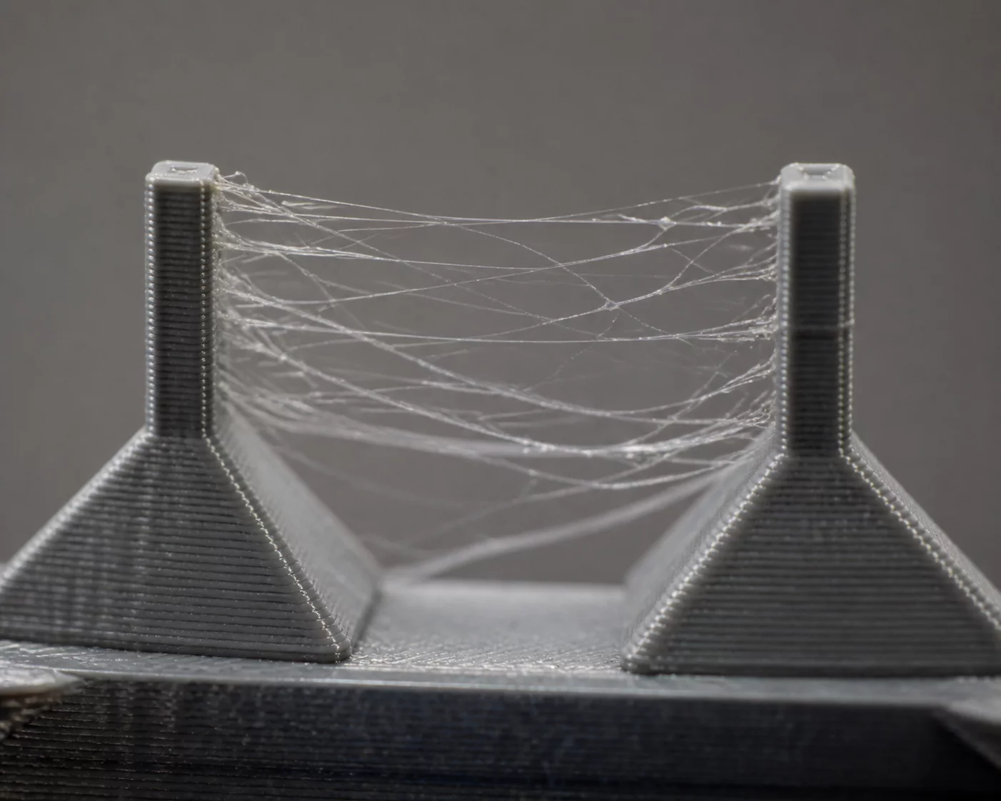 Stringing and Oozing thermoplastic filament strands